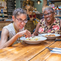 Two people eating lunch in a cafe